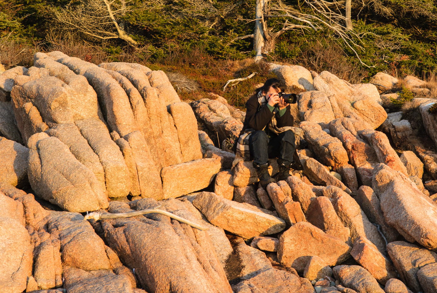 Anne sitting on rocks to take a photo, Barred Island
