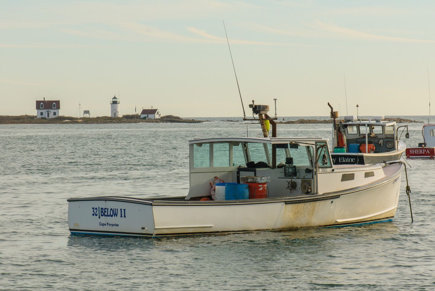 Boat and lighthouse in Cape Porpoise, Maine