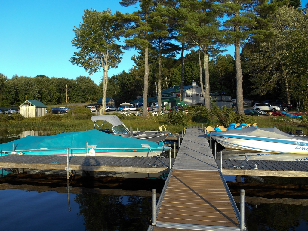 View down the dock toward boats and the Cyndi's Dockside building in warm evening light