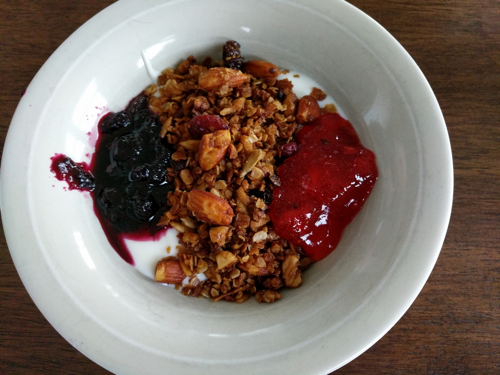 Bowl of granola with jams over yogurt