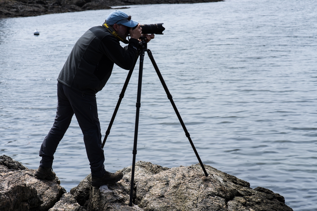 Paul taking a picture on rocks