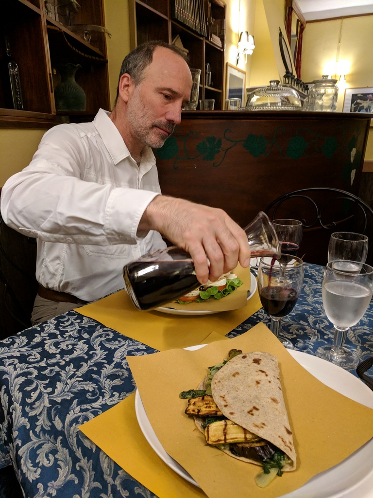 Paul pouring wine at the restaurant
