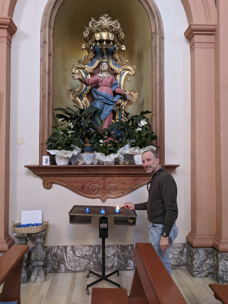 Paul lighting a votive candle