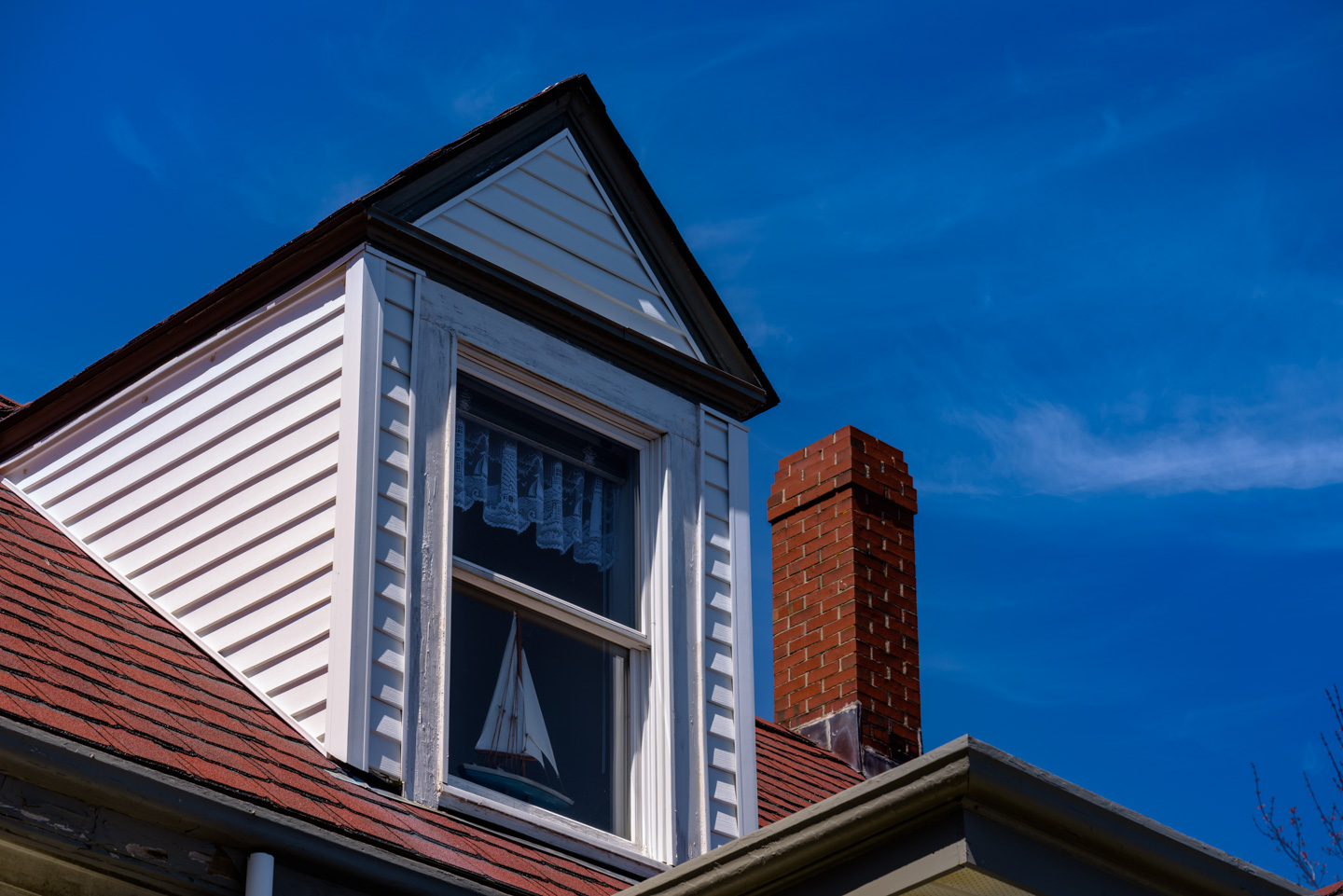 Model sailboat in window