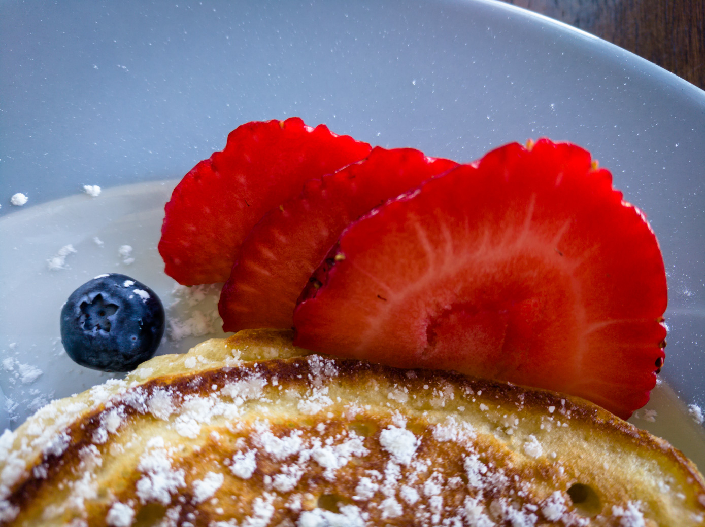 Pancakes decorated with sliced strawberry