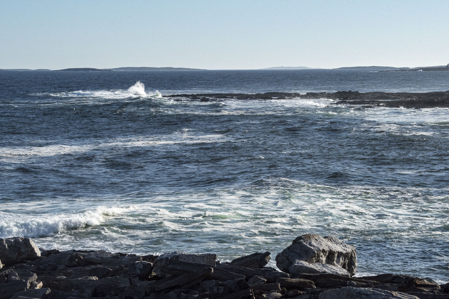 View into the water with a shallow area in the middle of the photo