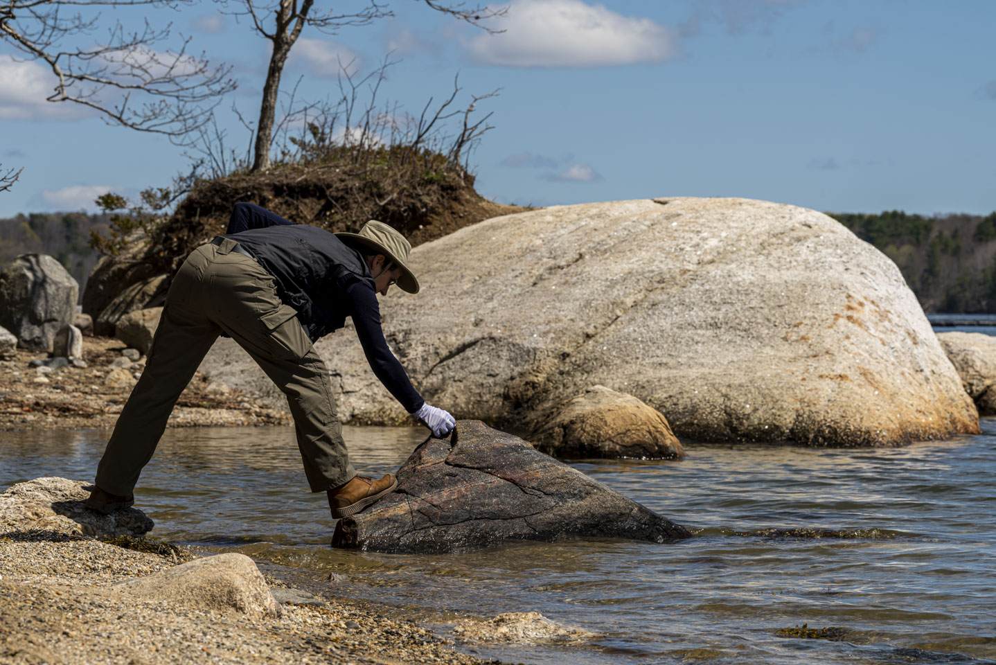 Anne placing a stone on a larger rock