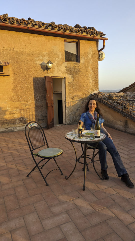 Anne sitting on the rooftop terrace on a warm evening