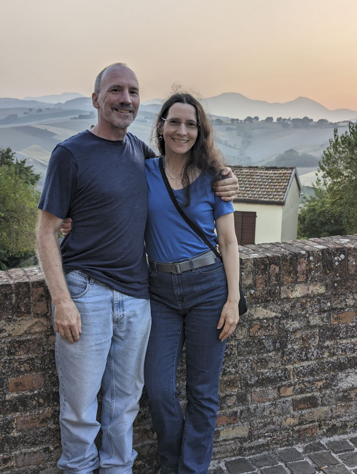 Paul and Anne next to a stone wall in Loretello