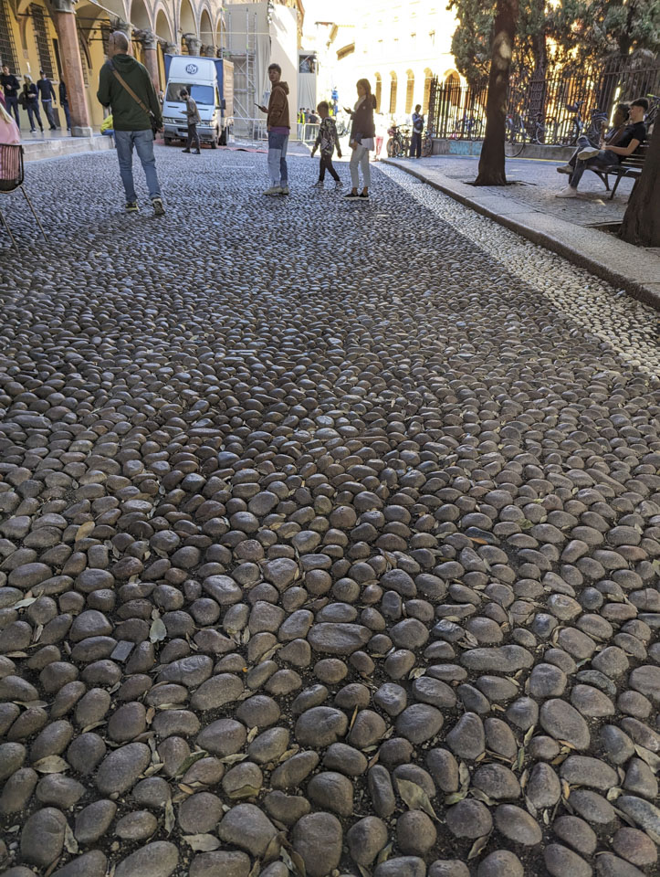 A cobblestone road in Bologna that has very small cobbles.