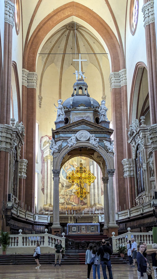 A picture of the large main altar with a tall and ornate portico over it.