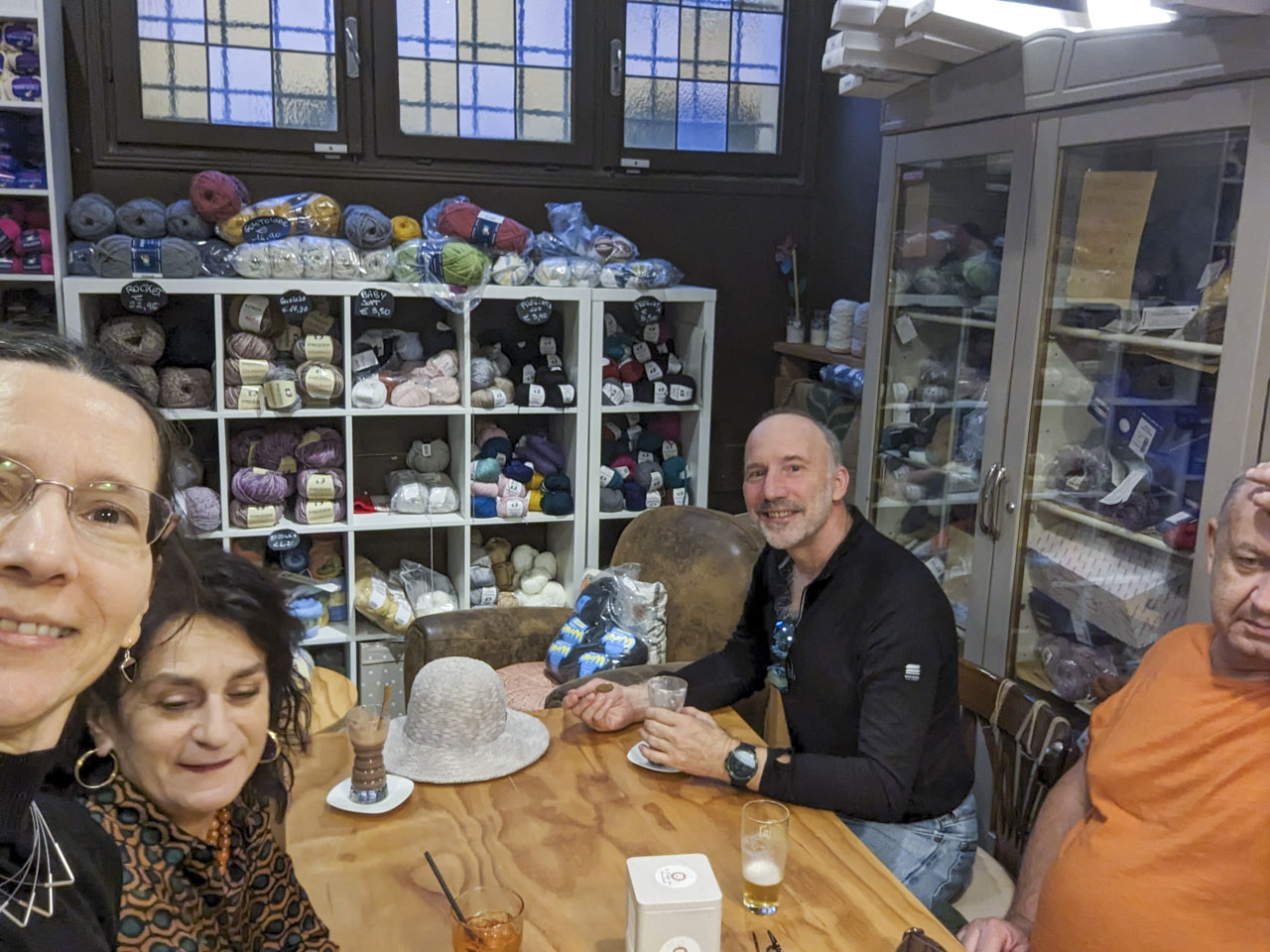 Anne, Doni, Paul, and Francesco sitting around a table at a shop that was combination yarn store and coffee shop.