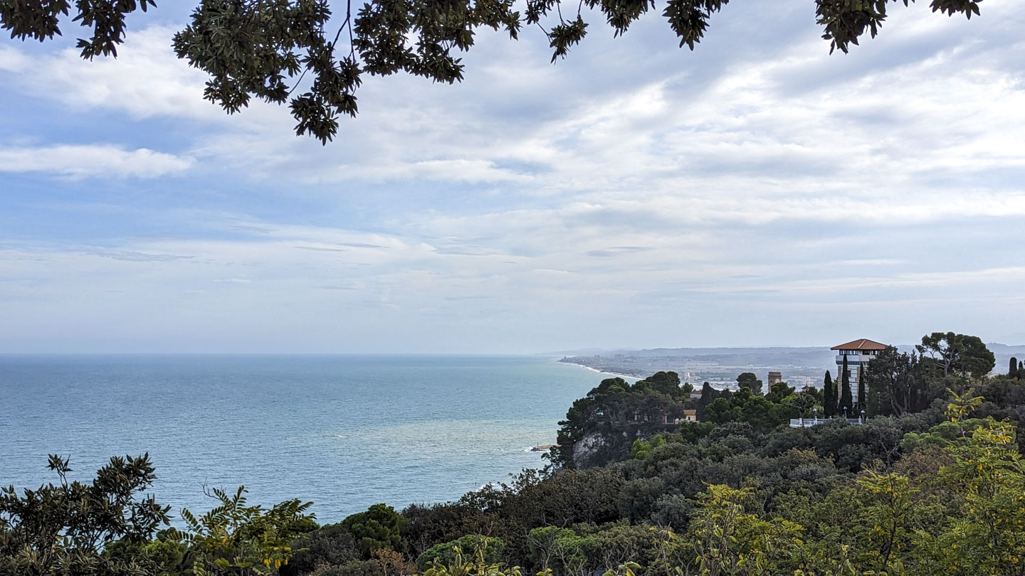 The sea is on the left of the photograph, with fairly flat land extending out on the right side.