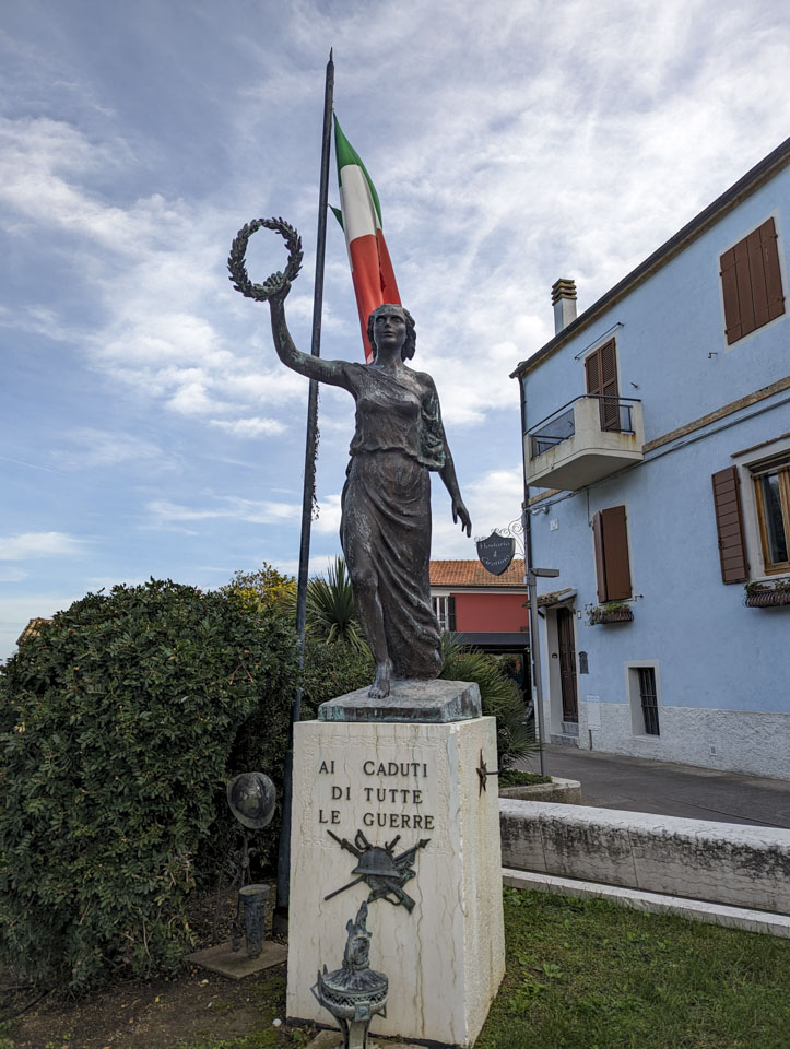 A memorial to those who have fallen in war. It is a woman in a flowing robe holding a laurel wreath in one hand.