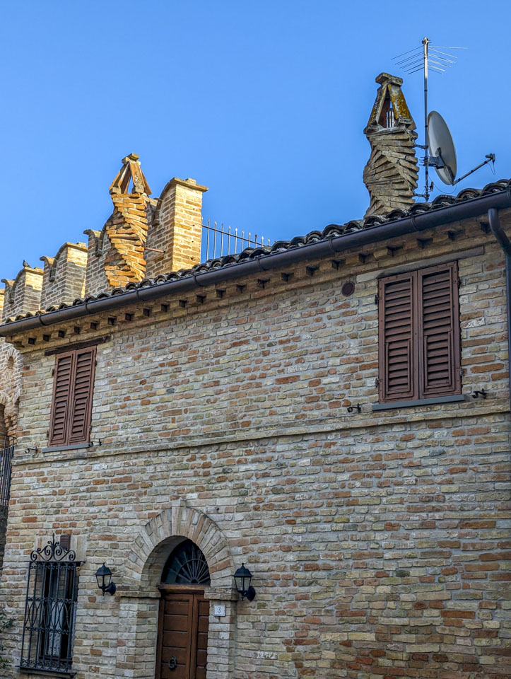 House with brick chimneys that have a twisting shape