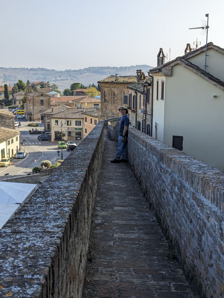Paul on a wall walkway in Corinaldo