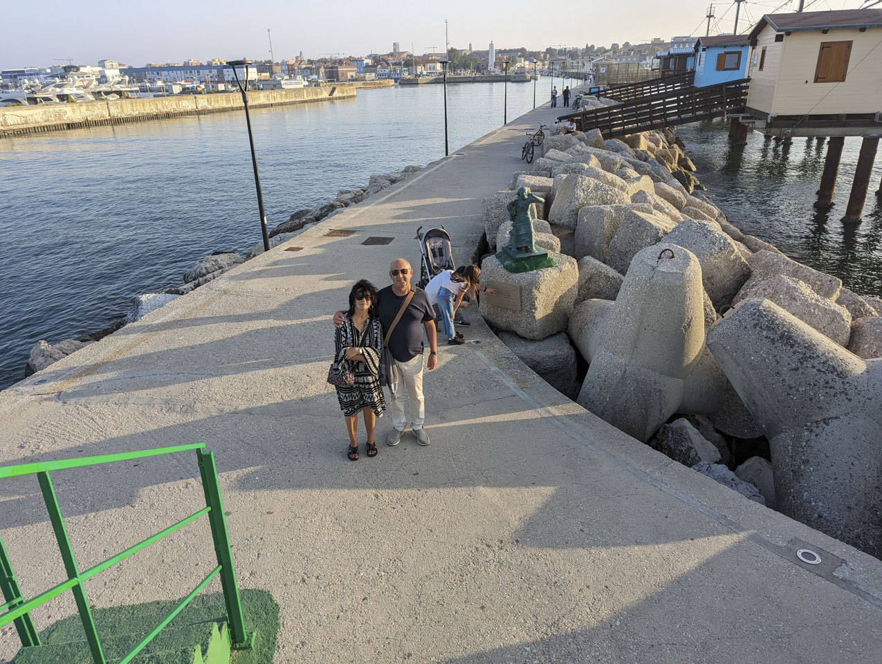 Doni and Francesco, standing near the statue of a woman and child