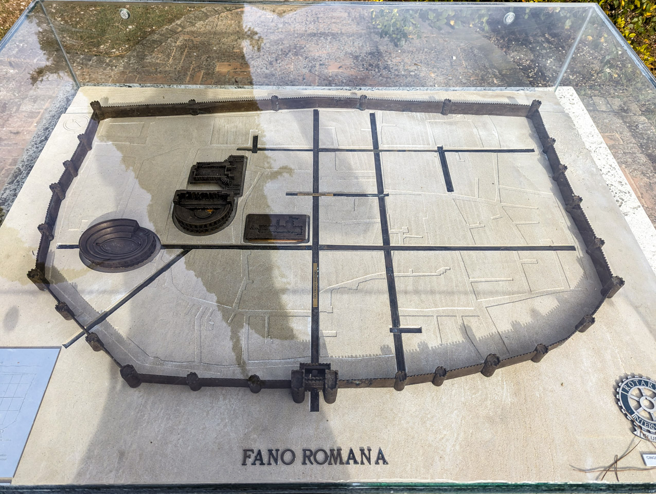 Looking down on a diorama of Roman era Fano. It shows the outside wall, some streets, and some arena style buildings.