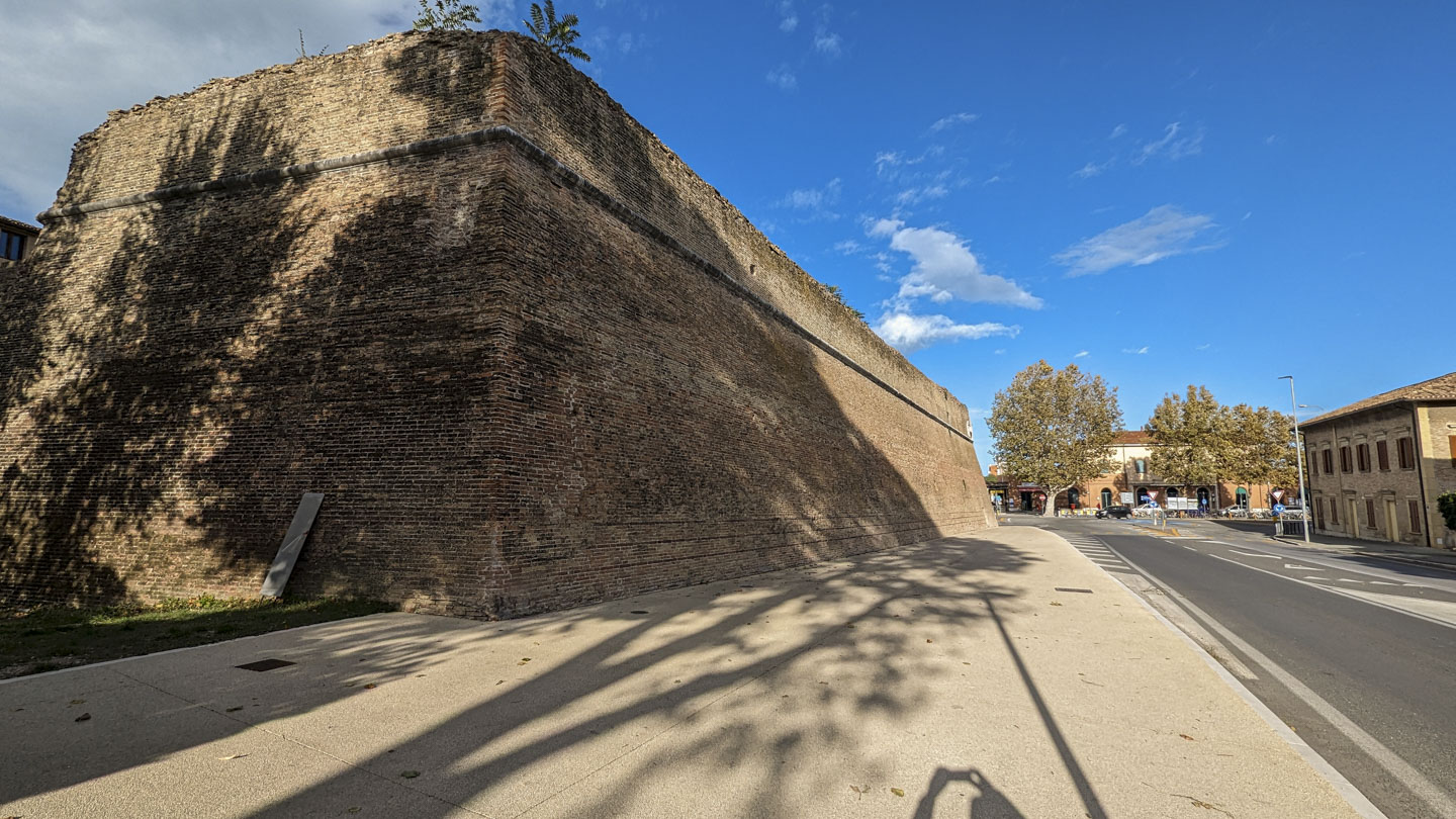 View of a very tall wall viewed from outside of the fortified area