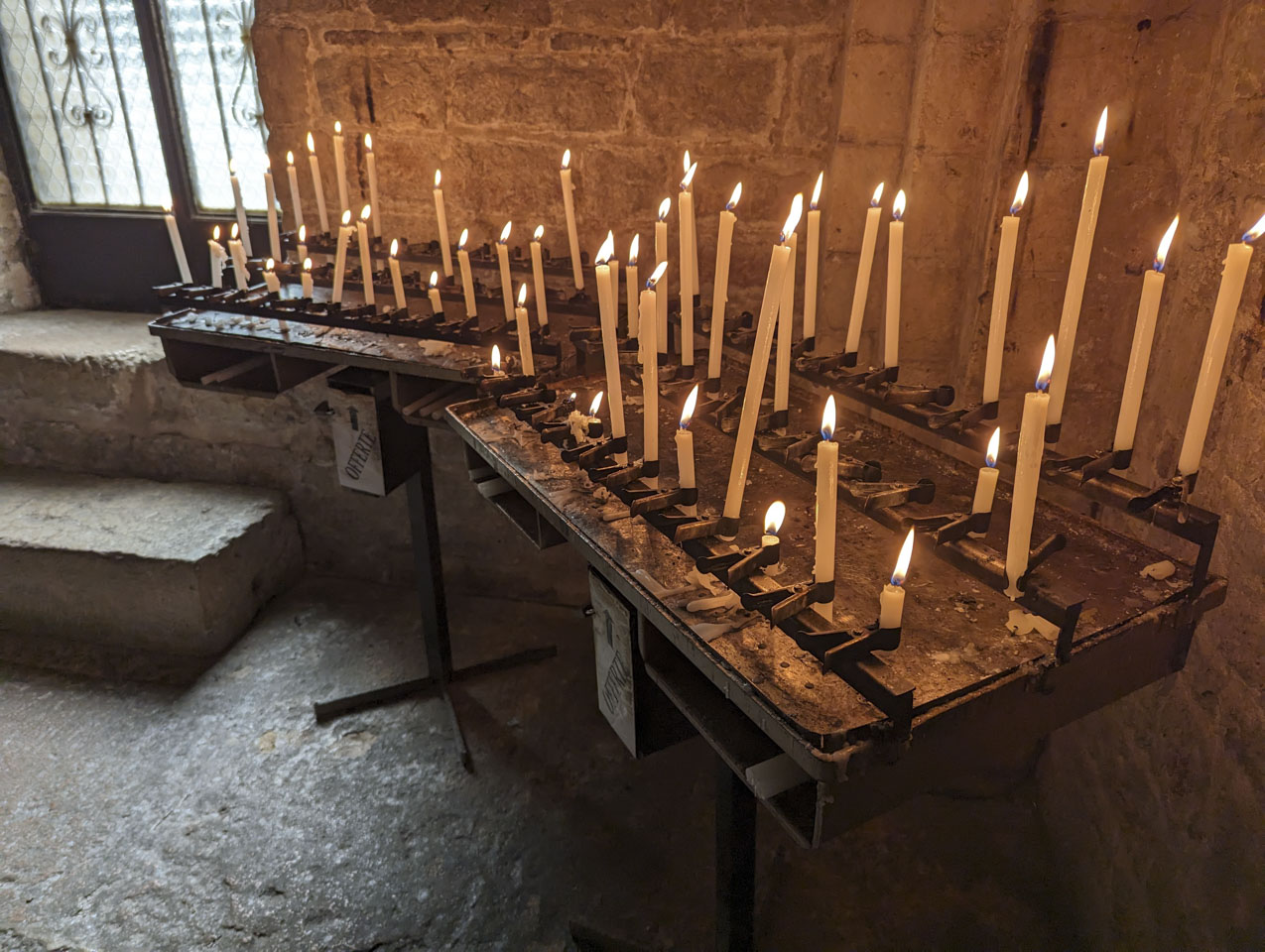A collection of candles in the Abbey of San Vittore