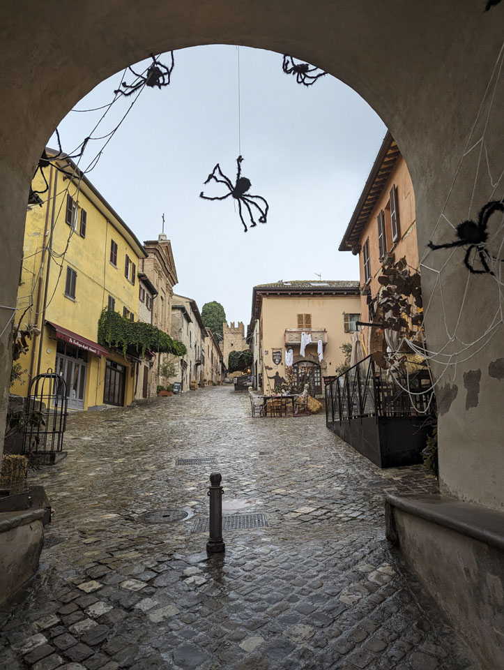 Looking through the archway into Gradara, with large artificial spiders