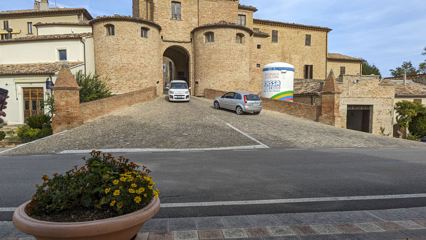 The Porta Maggiore to Mombaroccio with a car exiting while another car waits to enter.