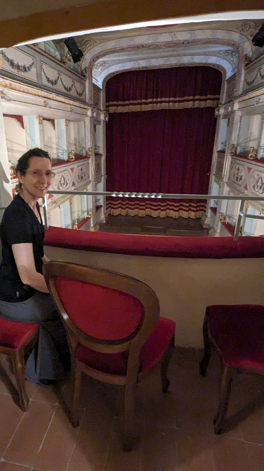 Anne inside a box seat on the middle balcony