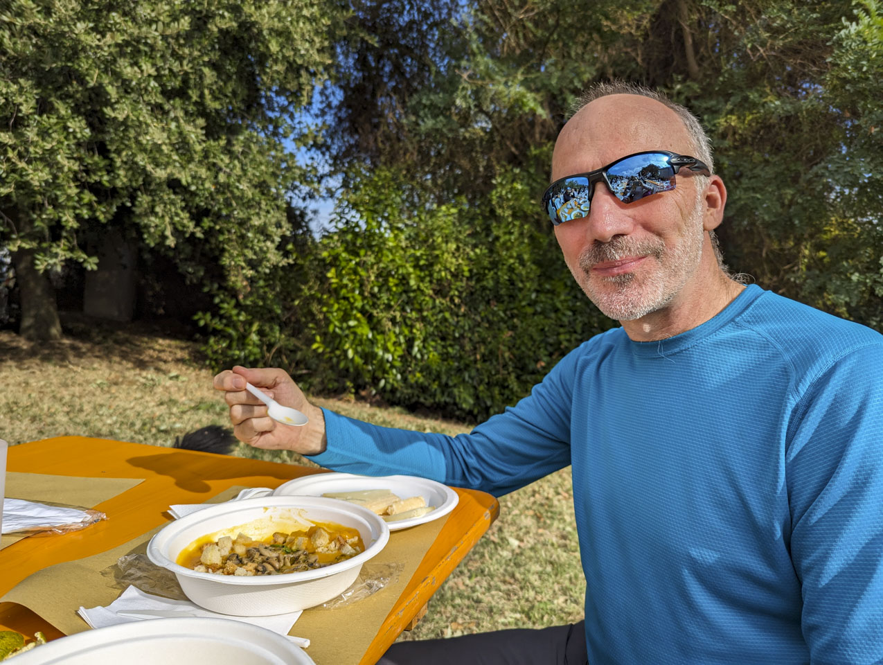 Paul sitting at a table with a spoon and a bowl of soup.