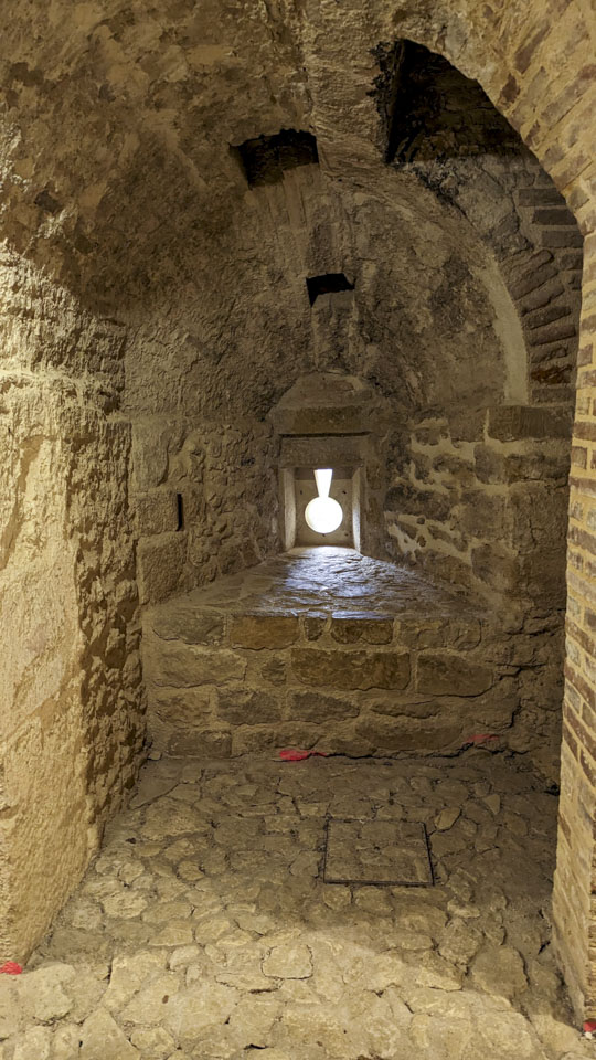 An upside-down keyhole shaped opening in a recessed area of a wall.