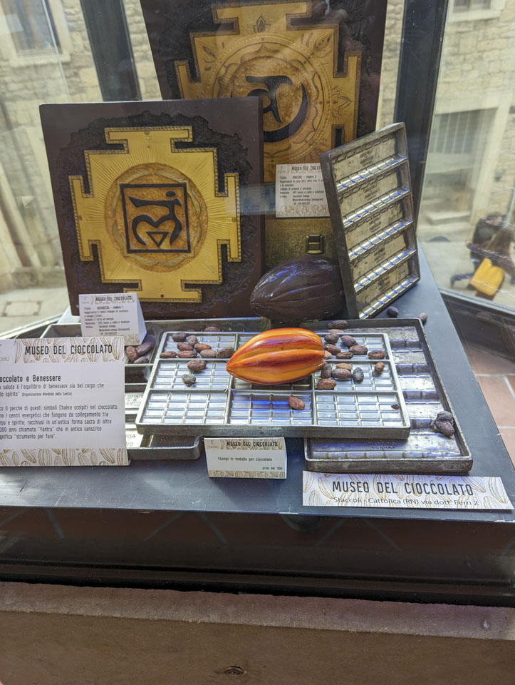 A small display showing models of cocoa beans and some forms used in the making of chocolates.