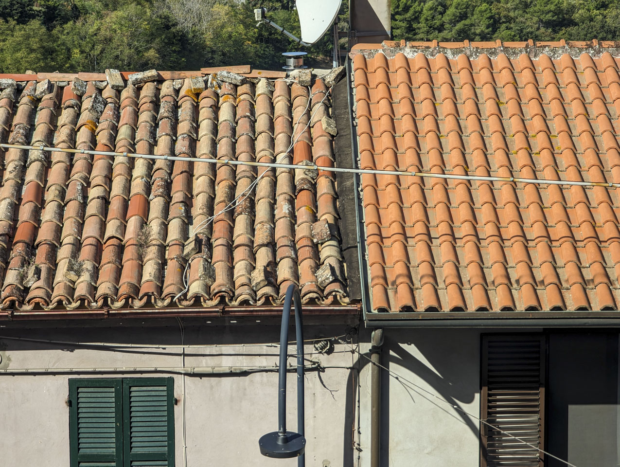 Two roofs that abut, one in an old style and one in a new style.