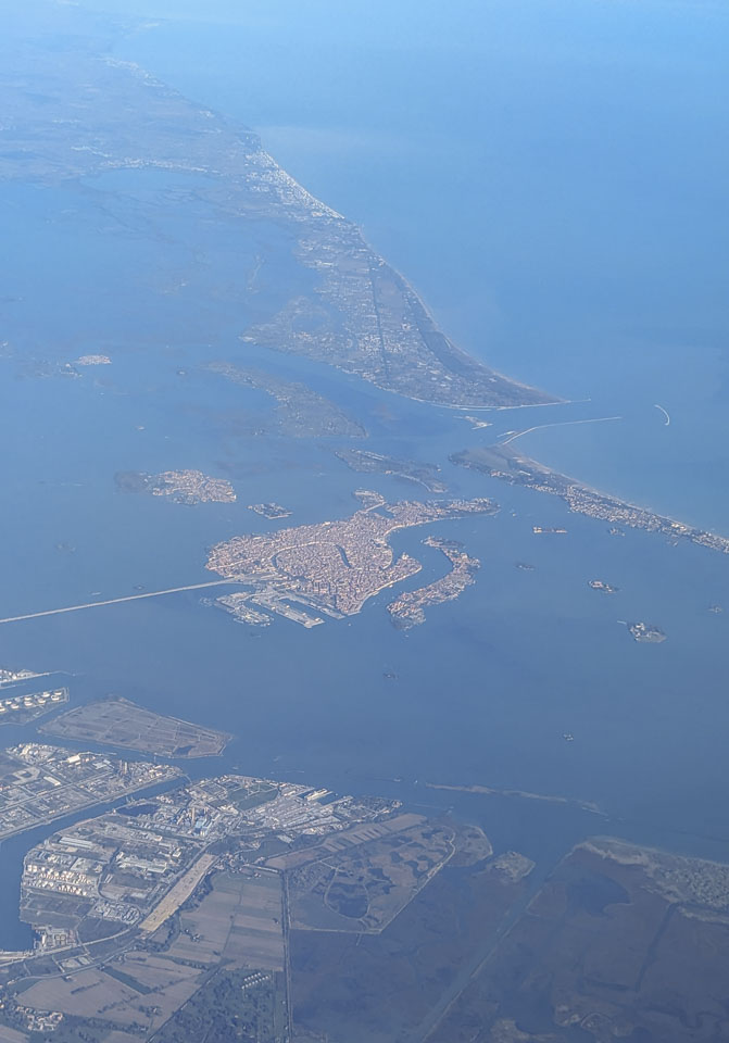 Looking through an airplane window down at Venice.