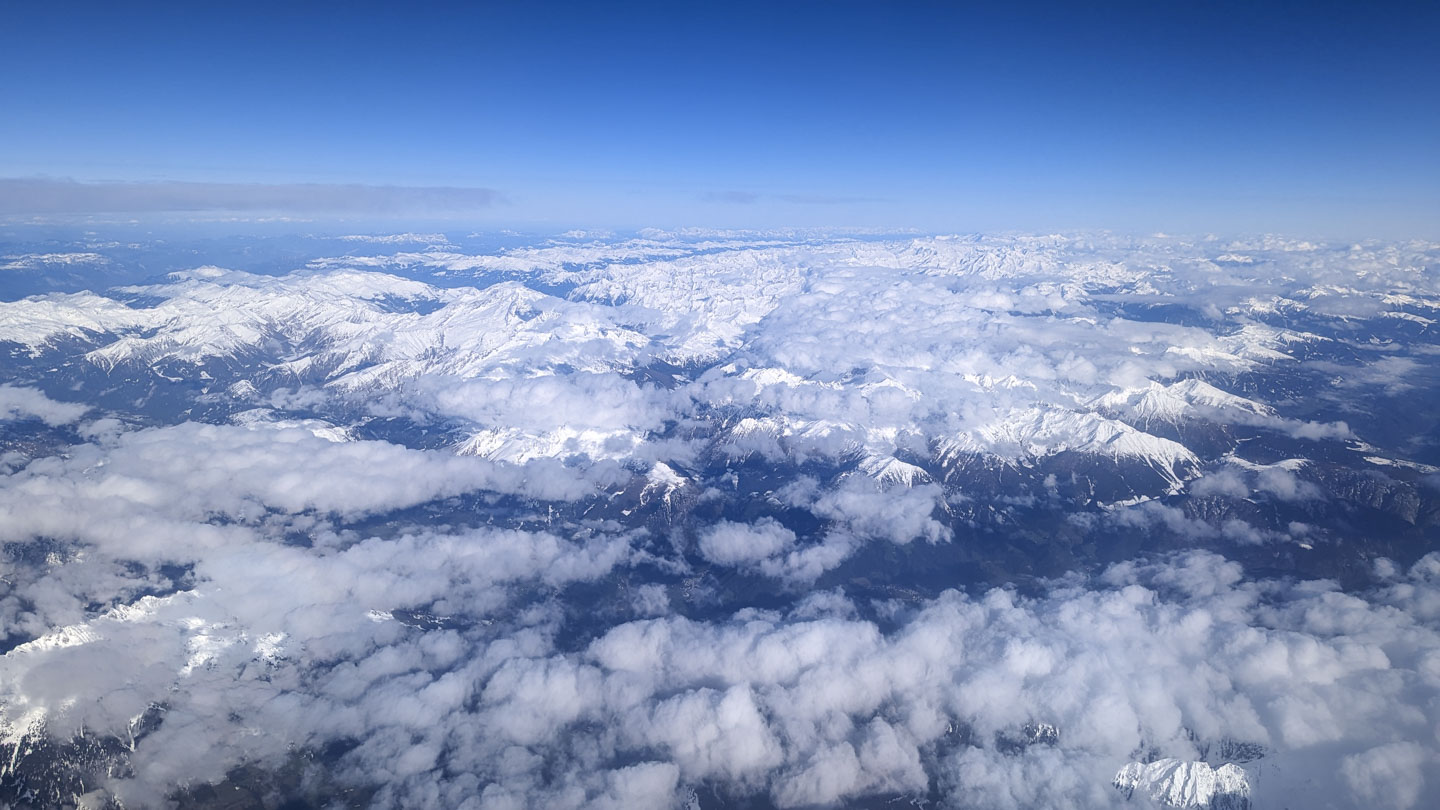 View from the airplane of clouds and mountains