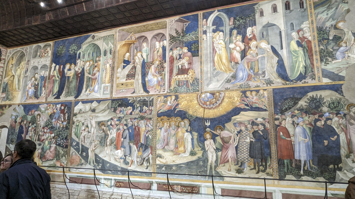 Painted panels on a wall. Each panel depicts a different part of the life of Saint John the Baptist.