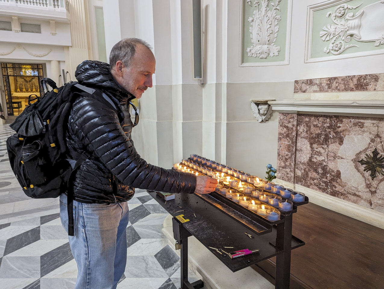 Paul lighting a candle.