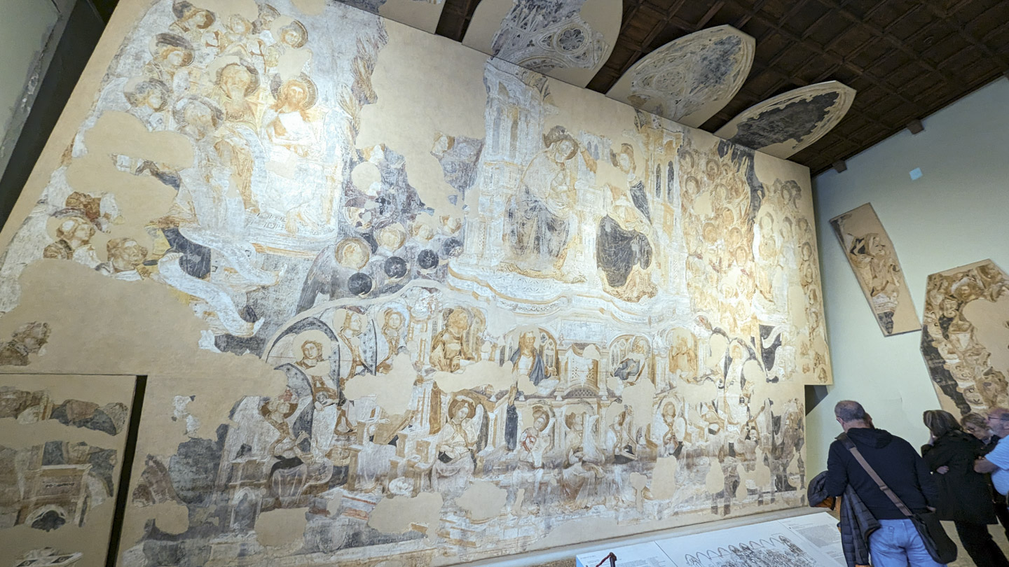 A pale wall that has many partial pieces of intricate artwork