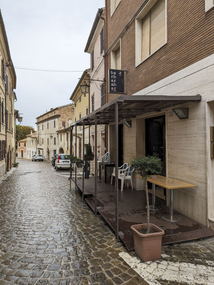 Looking down a street in Barbara with the bar on it. The sign has ba-rb-ar-ab-ar with 2 letters on each line