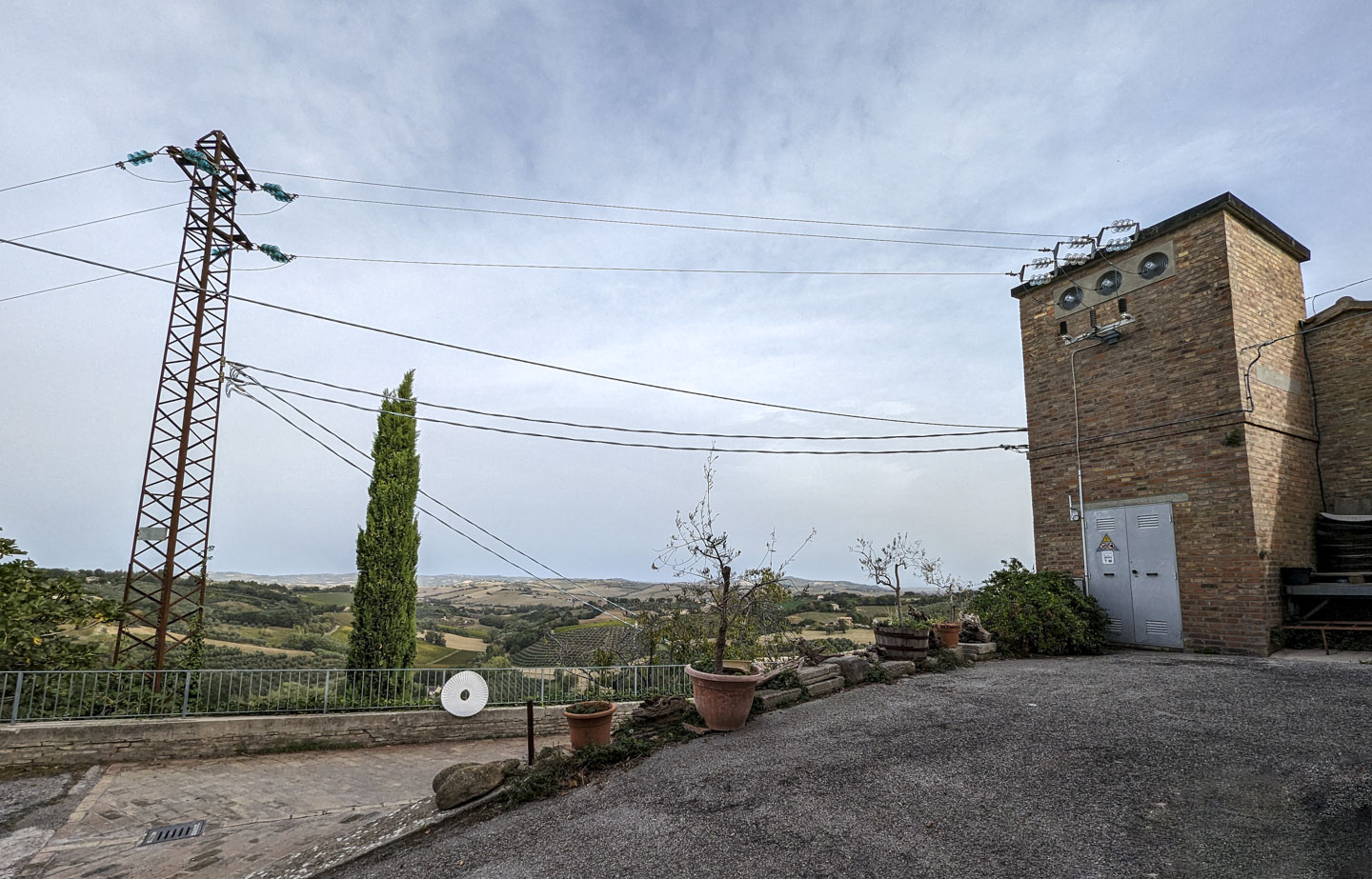 A large metal power line support with lines leading to the local substation.