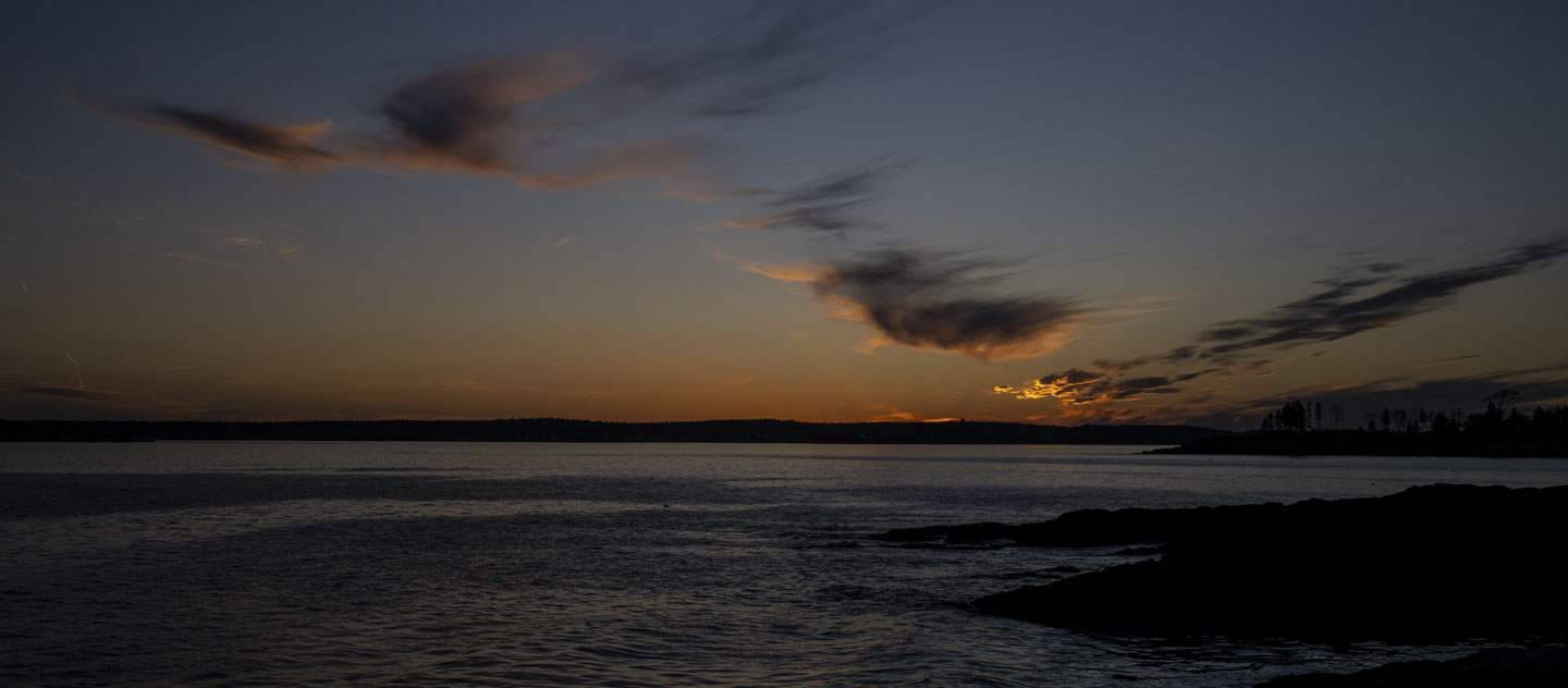 After sunset, there is still a glow on the clouds and the water can be seen. 