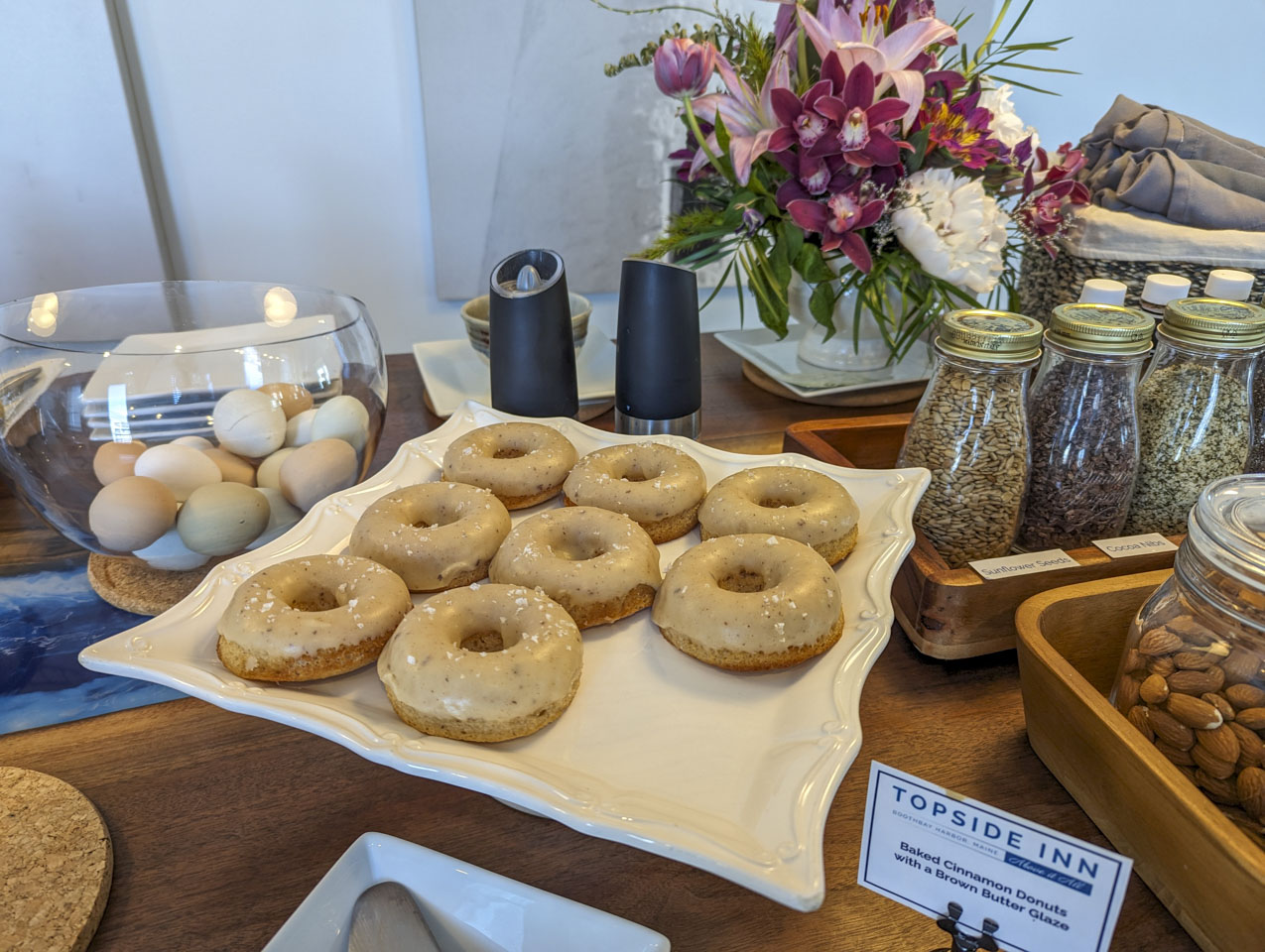 The donuts, arranged on a white cake stand.