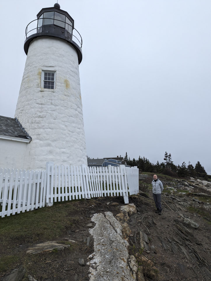 The Pemaquid Point Light. Paul is standing next to the picket fence, which is not handing in the air due to ground erosion from the storm.