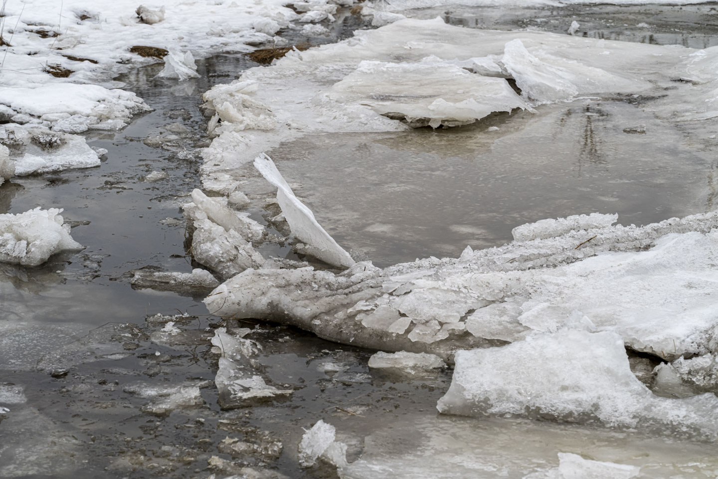 Ice on the river, with some of the ice standing vertically.