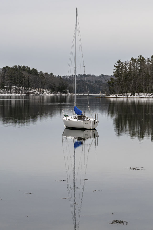 A sailboat is anchored in the water.