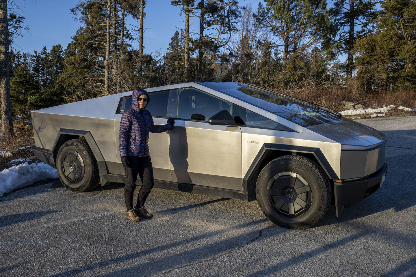 Anne is standing next to a Cybertruck