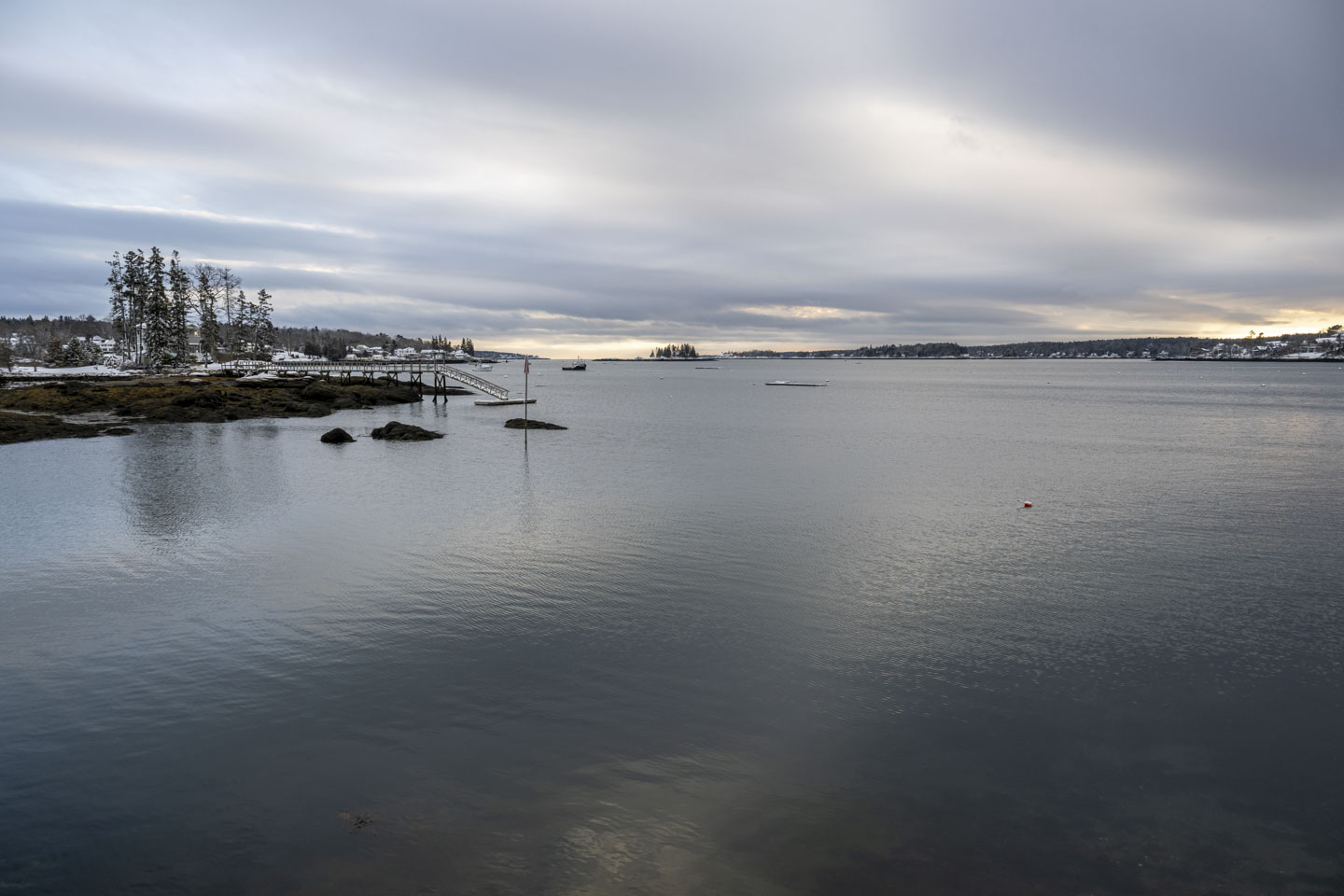 The water of Boothbay Harbor has a subtle glow in the late day light on a cloudy day.