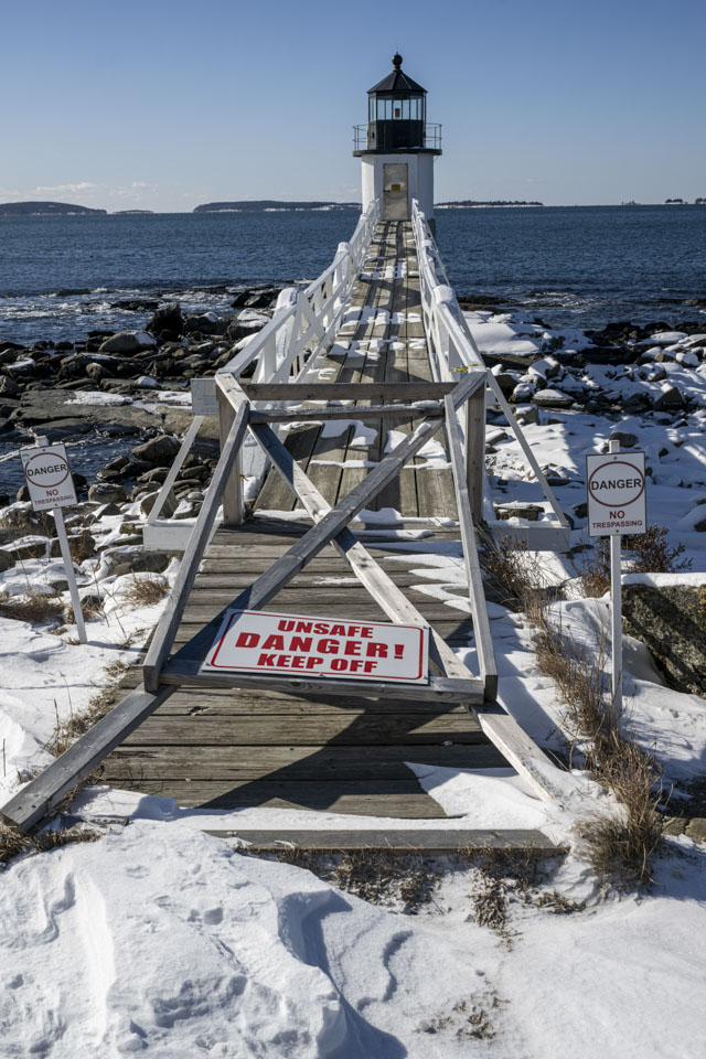 The bridge to get to the lighthouse has a sign stating it is unsafe.