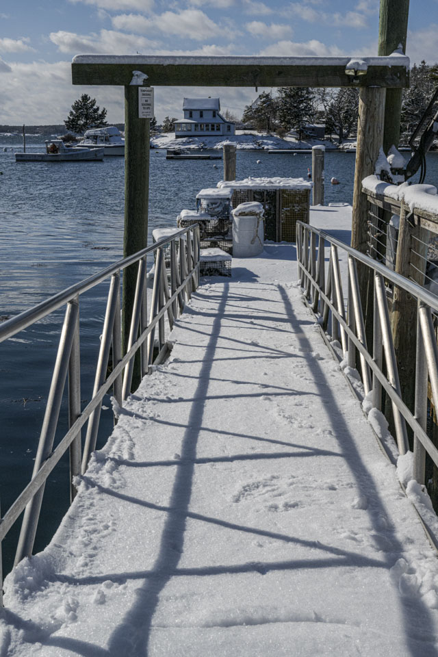 The ramp down to the floating dock is covered with snow.