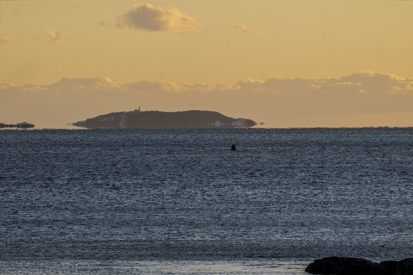 Seguin Island, with the lighthouse visible on the top, looks hazy because of the distance.