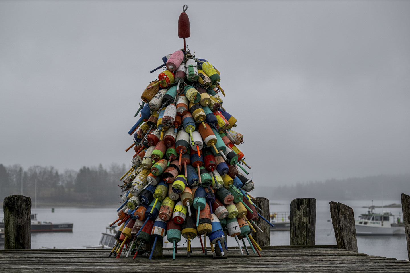 Buoys of many different colors are tied together in a tree shape.