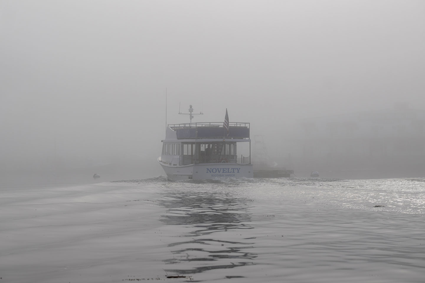 The boat Novelty goes into the fog.